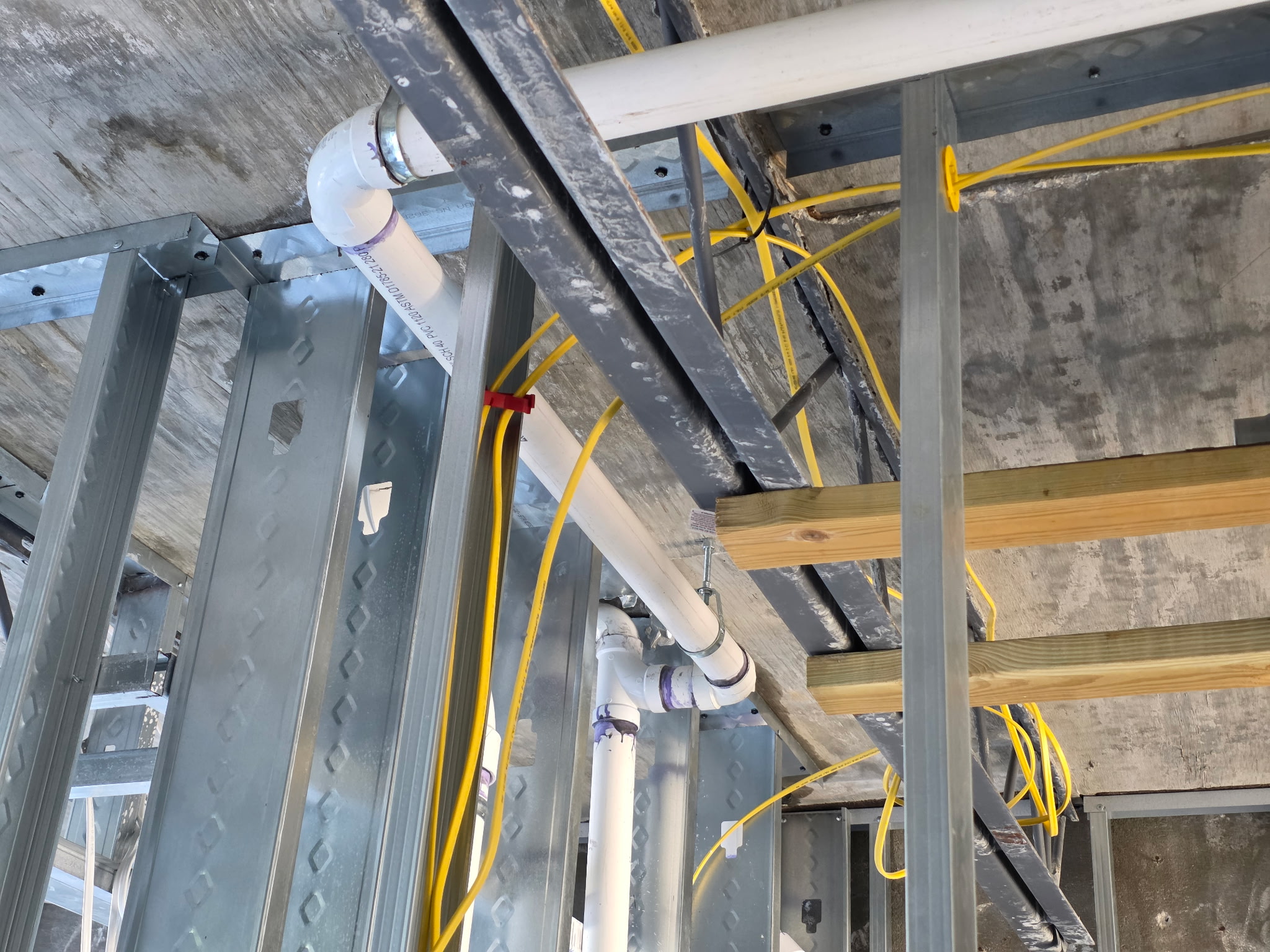 Drain and vent piping through structural framing