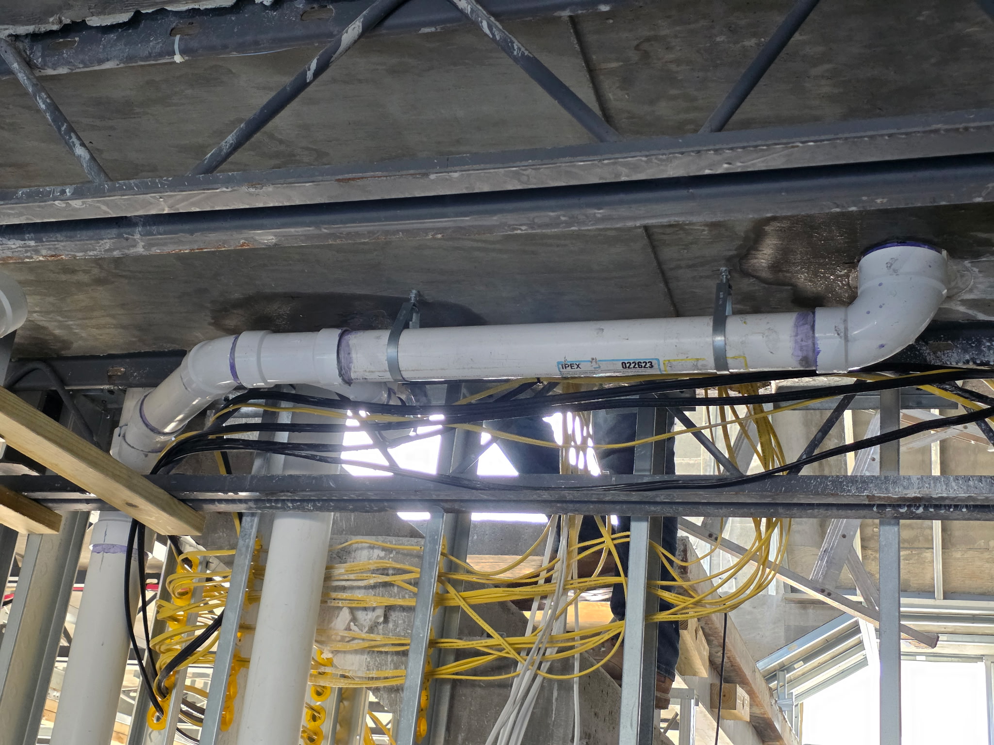 Overhead sanitary drain line installation